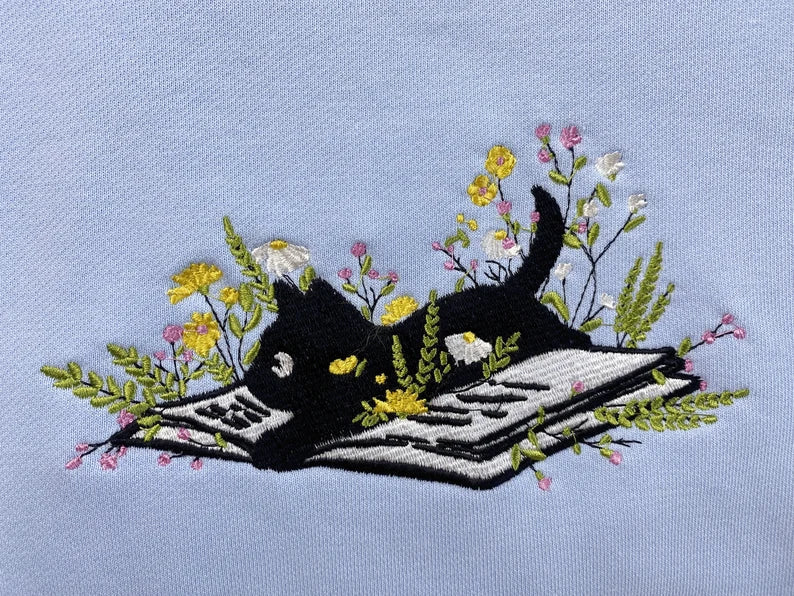 Cute Cat Lying On Book With Flower Embroidered Book Sweatshirt