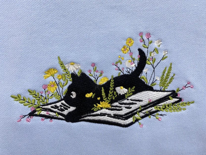 Cute Cat Lying On Book With Flower Embroidered Book Sweatshirt